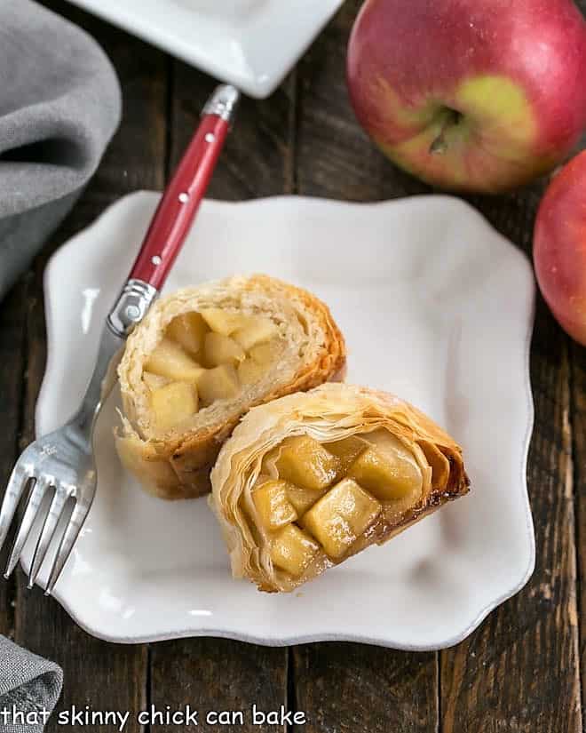 This Strudel Recipe is flaky, delicious and filled with sweet, cinnamon-spiced apples 2 slices of apple strudel on a square white plate