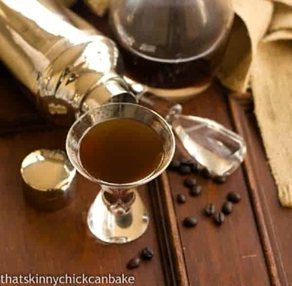 Homemade Kahlua - An easy, homemade holiday gift! Homemade Kahlua in a glass next to a carafe of Kahlua.