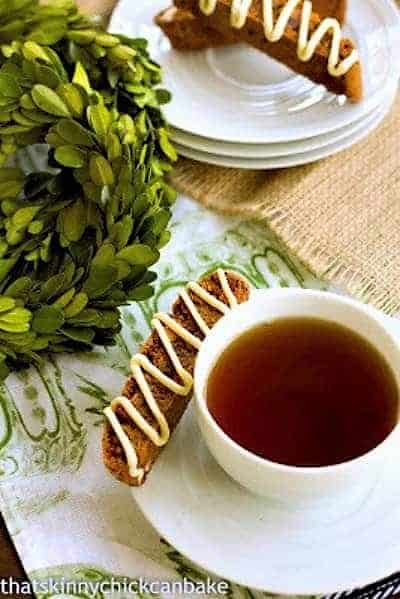 Gingerbread Biscotti - Perfect holiday treats! Gingerbread Biscotti on a stack of saucers and with a cup of tea