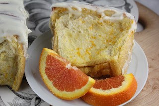 Orange Pull-Apart Coffee Cake - a unique, delicious bread recipe flavored with orange! Slice of orange coffee cake on a plate with orange slices.