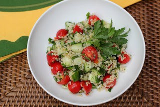 Tabbouleh Recipe - a healthy, refreshing whole grain salad filled with tomatoes, cucumbers and more with a lemon olive oil salad dressing Overhead view of tabbouleh recipe in a white bowl garnished with parsley