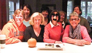 A group of friends sitting at the kitchen bar after a food demo of how to make cheesecake!