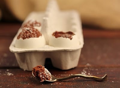A close up of a3 egg shaped brownies with spoonful removed from one egg