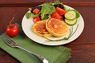 Potato pancakes on a white plate with a green napkin