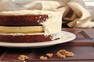 Cheesecake filled carrot cake partly frosted Cheesecake Filled Carrot Cake