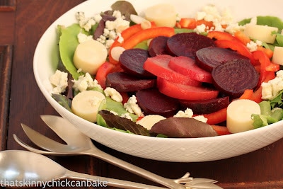 A close view of a beet salad in a white bowl.