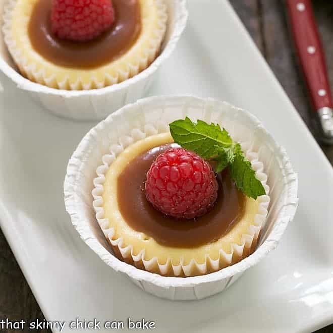 Caramel Topped Mini Cheesecakes - An exquisite combination of flavors and textures in this homemade cheesecake recipe Close overhead view of mini cheesecakes topped with caramel and mint