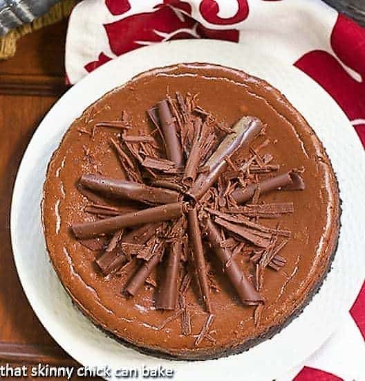 Double Chocolate Cheesecake - For those times when you need a chocolate desserts that will make jaws drop! Rich, decadent and chocolate!! Double Chocolate Cheesecake on a white plate with chocolate curls