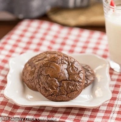 3 rich, fudgy cookies on a small white plate.
