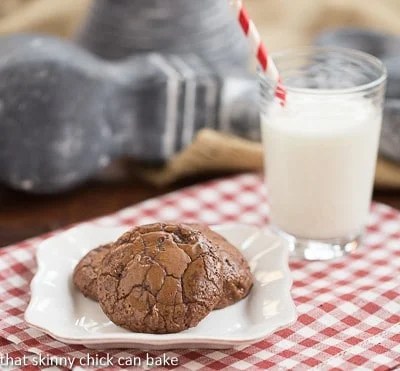 Double Chocolate Cookies - rich, fudgy cookies with two types of chocolate and chocolate chunks! Double Chocolate Cookies on a white plate with a glass of milk
