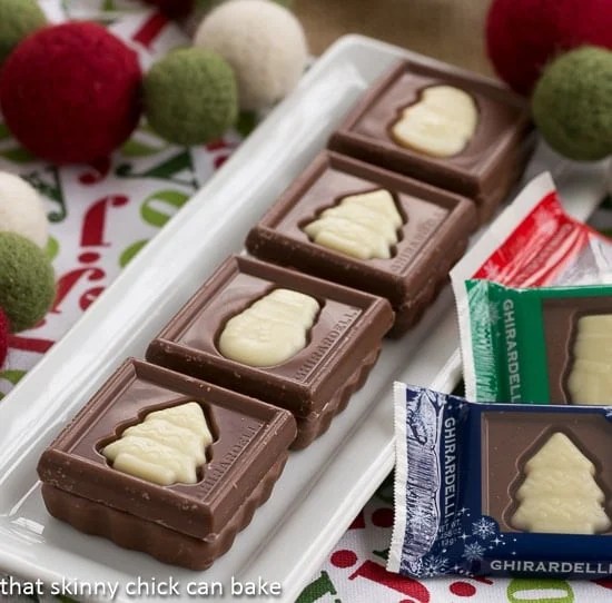 Festive Fudge Snowflakes and Squares - No fail fudge recipe in a fun holiday shape! Festive Fudge Snowflakes and Squares on a white rectangular tray.