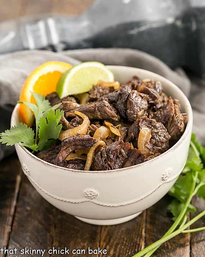 Vaca Frita - Scrumptious Cuban Shredded Beef Scrumptious Cuban Shredded Beef 45 degree angle view in a white bowl with a sprig of cilantro.