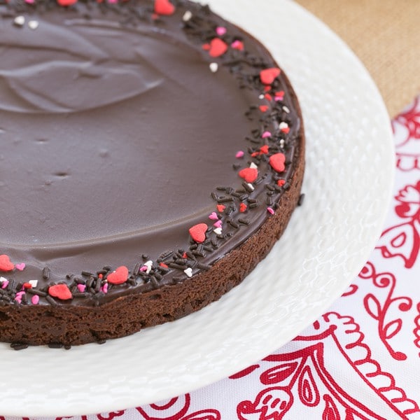 Uncut Ganache Topped Truffle Brownies on a white plate