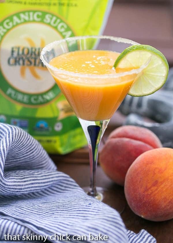 Fresh Peach Margaritas - Using peak of the season peaches, these margaritas are out of this world! Peach Margaritas in a martini glass garnished with a slice of lime.