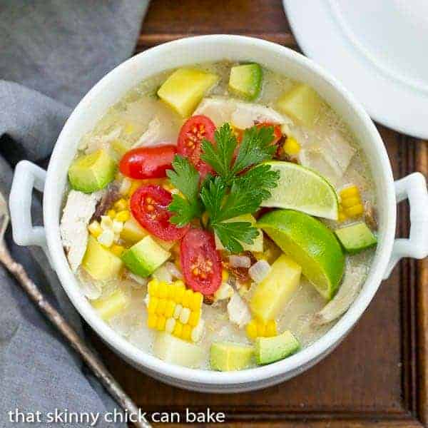 Bacon Corn Chowder - A summer soup full of corn, potatoes, chicken and smoky bacon! Overhead view of a tureen of bacon corn chowder.