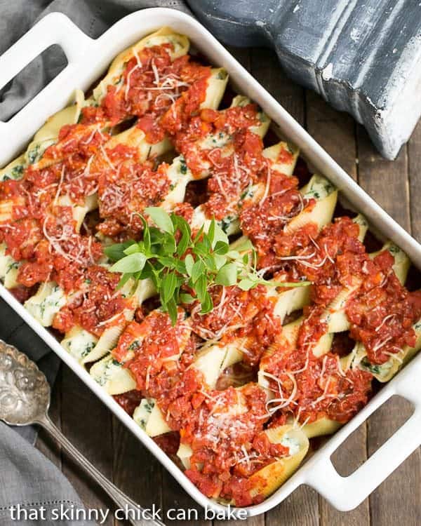 Spinach Stuffed Pasta Shells - A comforting casserole the whole family will adore! Spinach Stuffed Pasta Shells in a white ceramic casserole dish.