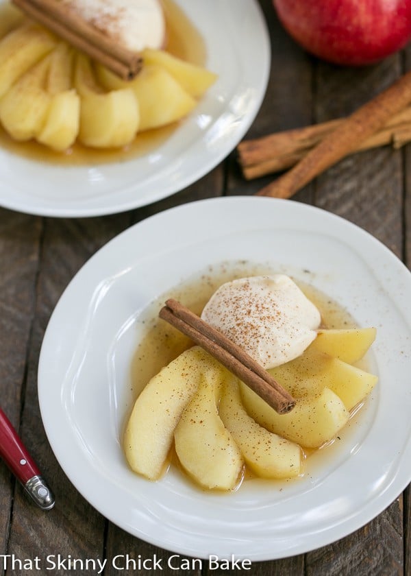 Tea Poached Apples - Tea, honey and wine poached apples with a dollop of Calvados spiked mascarpone cream Tea Poached Apples fanned out on dessert plates.