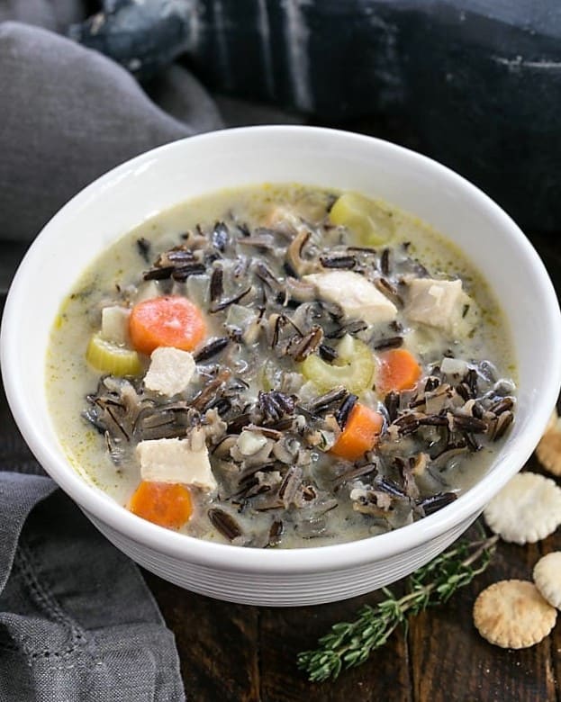 Cream of Wild Rice Soup is a velvety, hot, comfort food for a chilly day. I dug out my mom's Wild Rice Soup recipe and added chicken and some extra vegetables. This warm, comforting meal is easy to make! Closeup of a bowl of wild rice soup from above.
