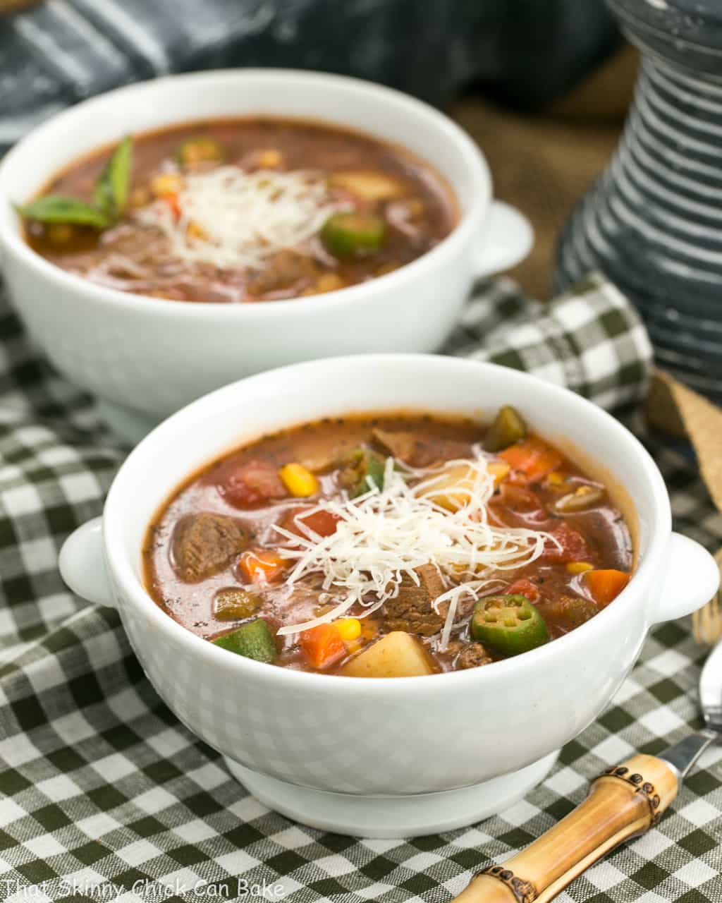 Beef and Vegetable Soup - A healthy soup recipe chock full of vegetables and lean beef Two bowls of Vegetable Beef Soup in white soup bowls on a green and white checked napkin.