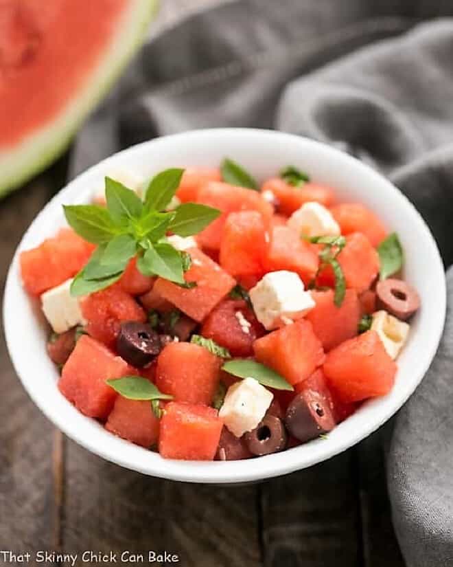 Watermelon Feta Basil Salad with Balsamic Vinaigrette - An unusual, refreshing and irresistible summer side dish! Watermelon Feta Basil Salad with Balsamic Vinaigrette in a white bowl.