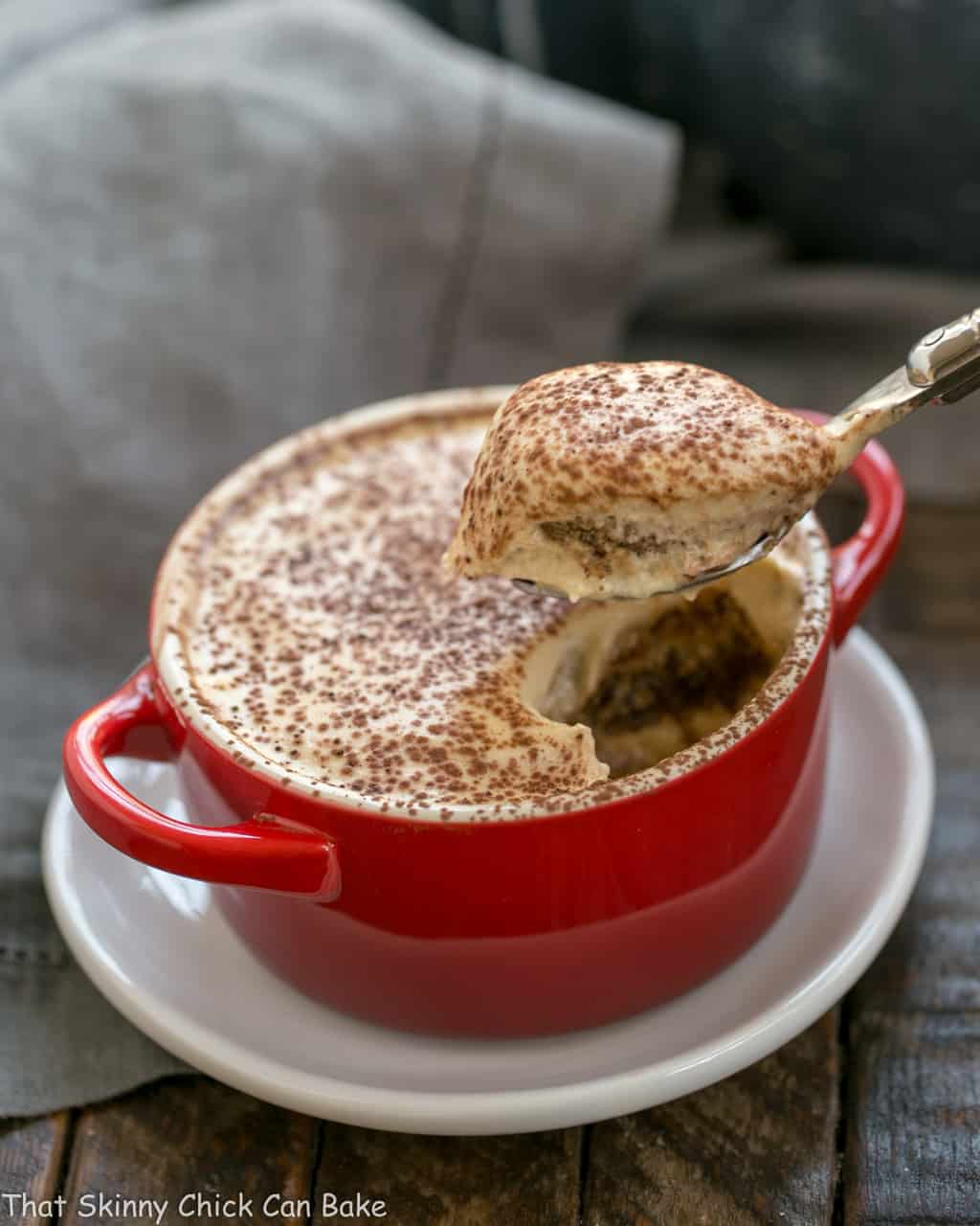 Kahlua Tiramisu for Two - Ultra creamy small batch tiramisu! Kahlua Tiramisu for Two in a red cocotte with a spoon.