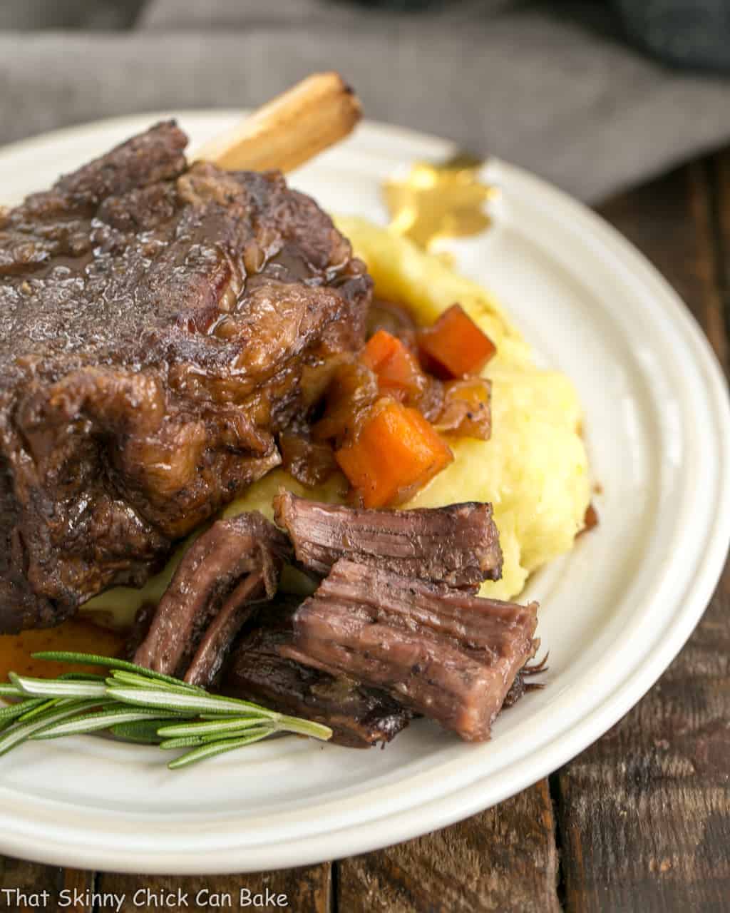 Instant Pot Beef Short Ribs - A quick cooking time make these short ribs a perfect dinner any day of the week Instant Pot Beef Short Ribs on a white plate with mashed potatoes.
