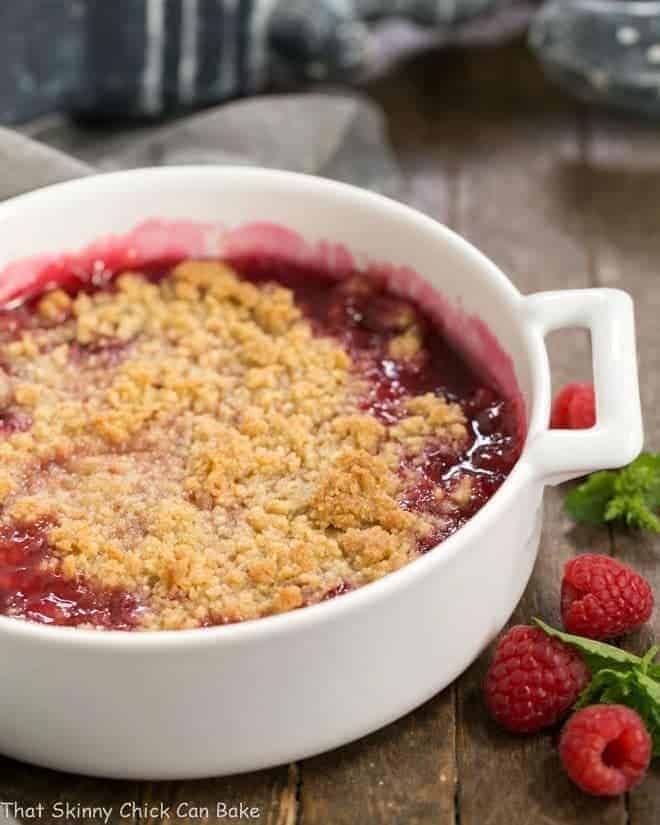 Fresh raspberry crisp with a simple streusel topping! With a scoop of vanilla ice cream you'll have a scrumptious, easy dessert!! Fresh Raspberry Crisp in a round white casserole dish