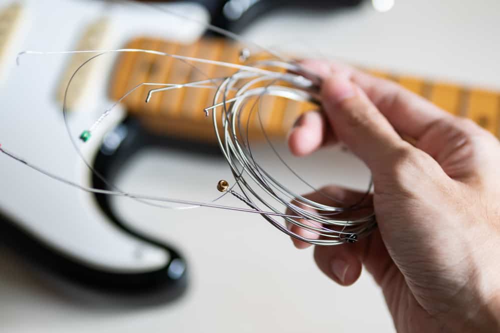How Much Does It Cost To Restring A Guitar? (2023 Updated)