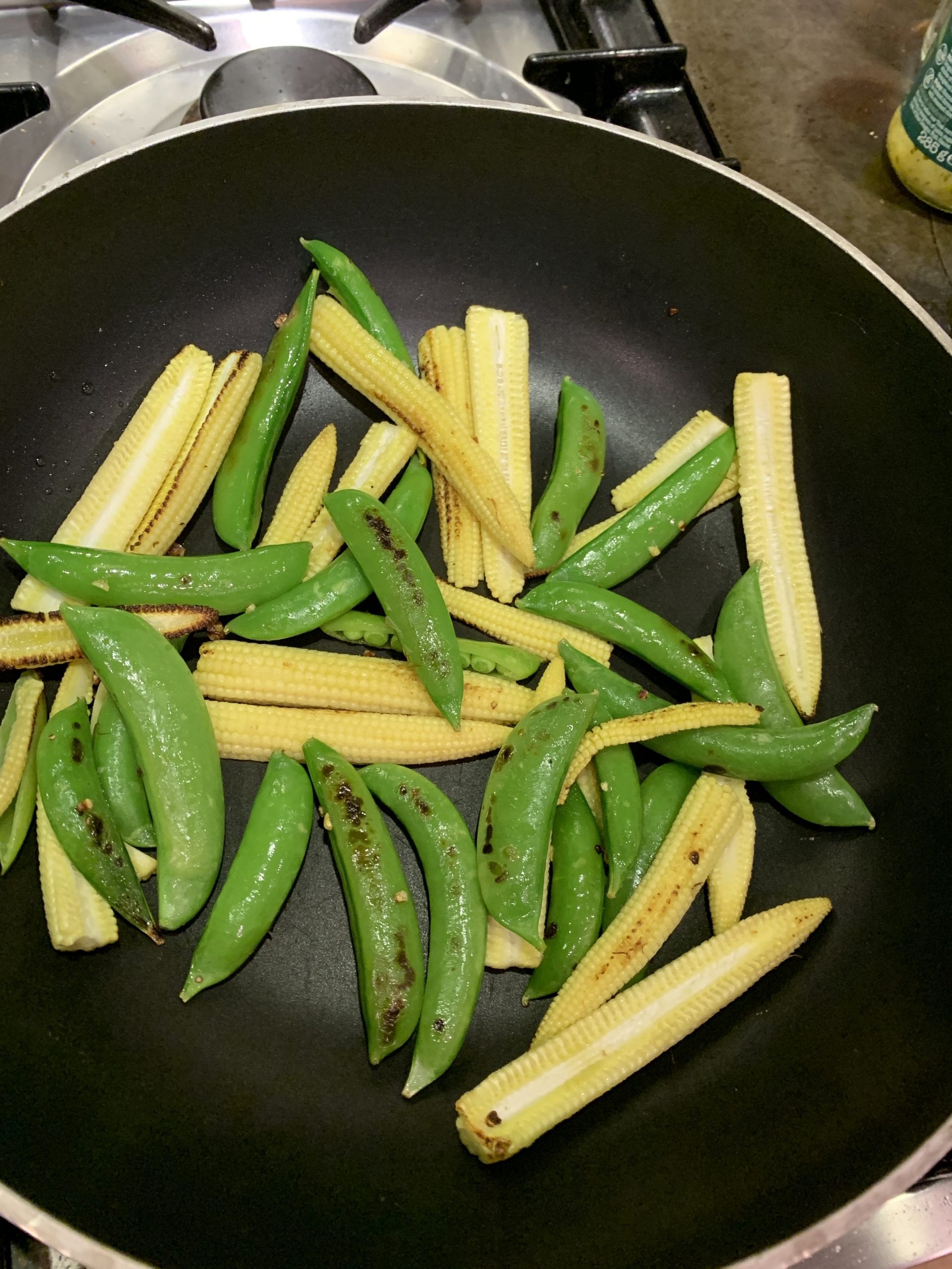 Charred Baby sweetcorn & sugarsnap peas in a spicy peanut sauce The