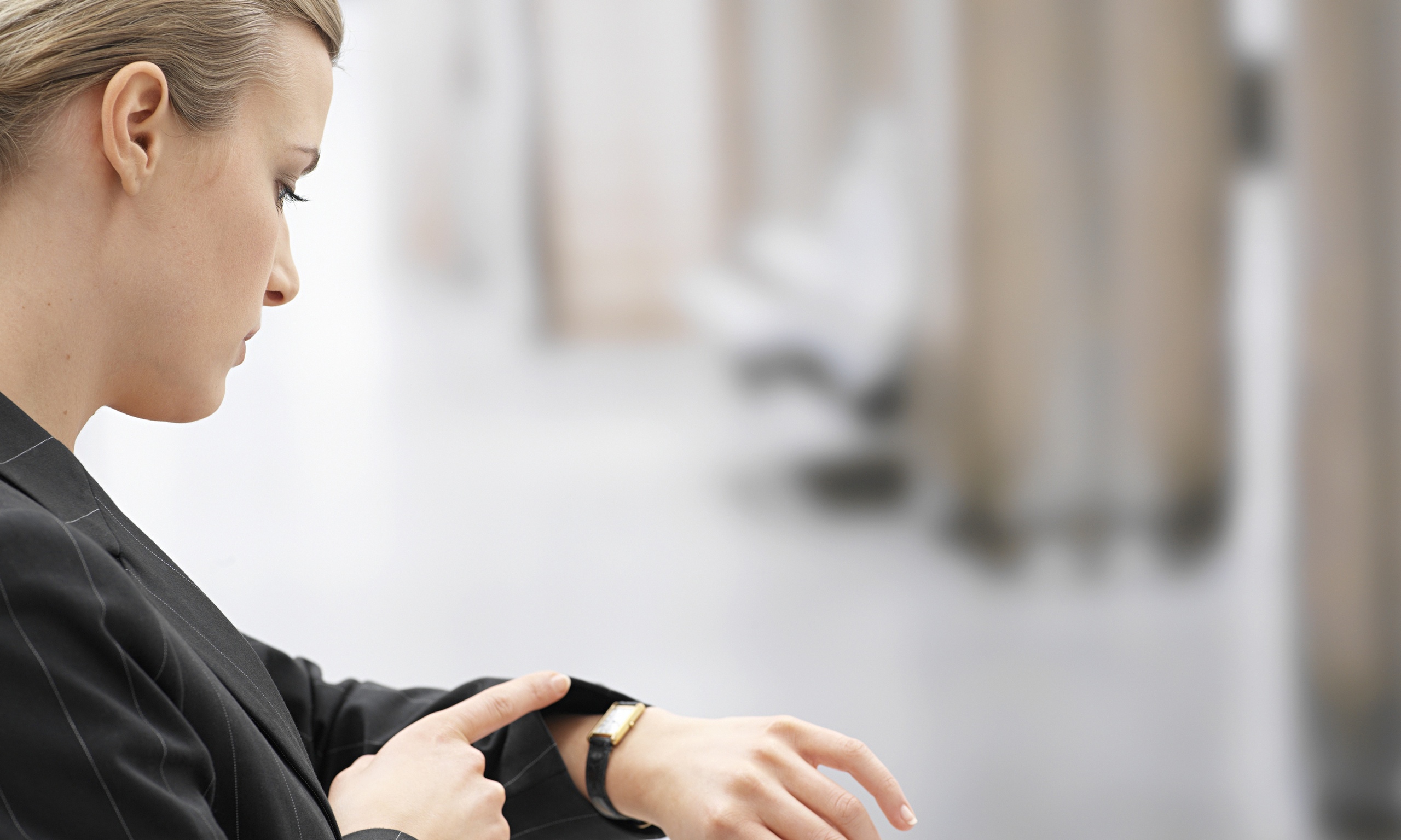 Young Woman Looking at Watch The Womens Room