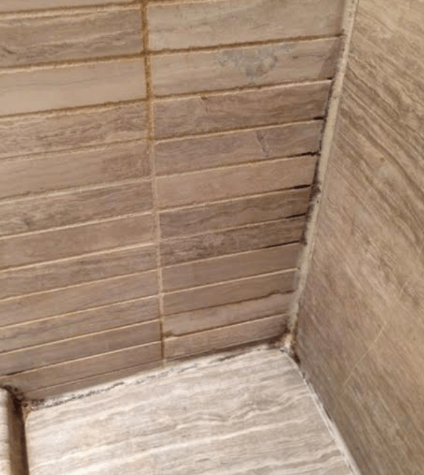 What's causing the discoloration in this tiled shower? TileLetter