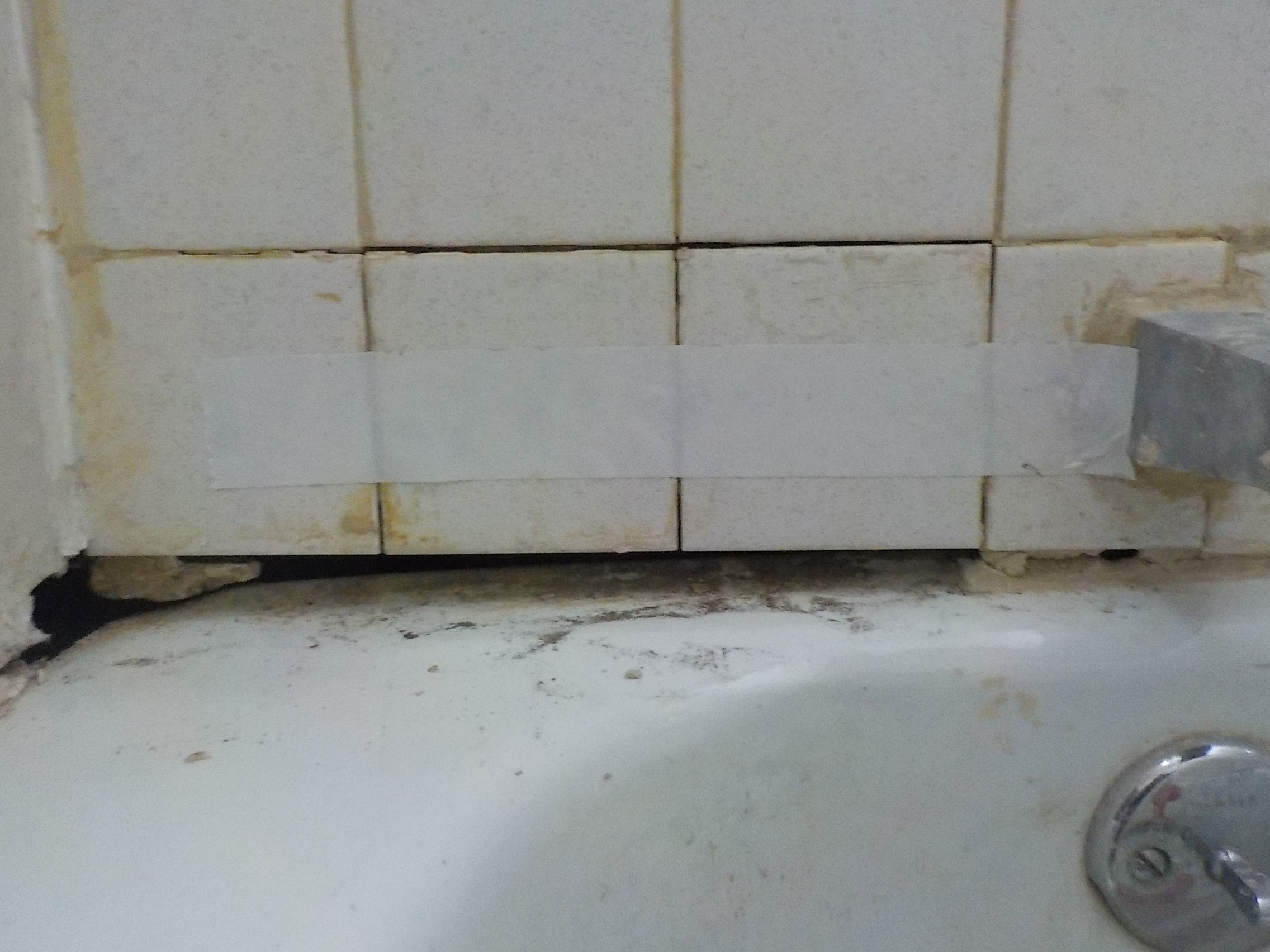 Need advice caulking a bathtub when the gap is BIG between wall tiles