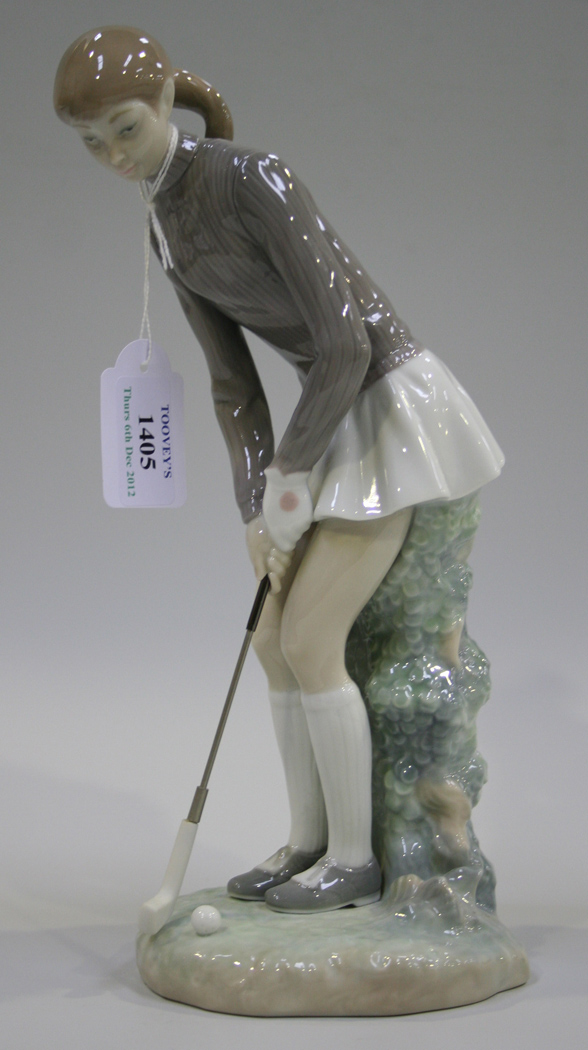 A Lladro porcelain figure of a young girl playing golf, model No. 4851