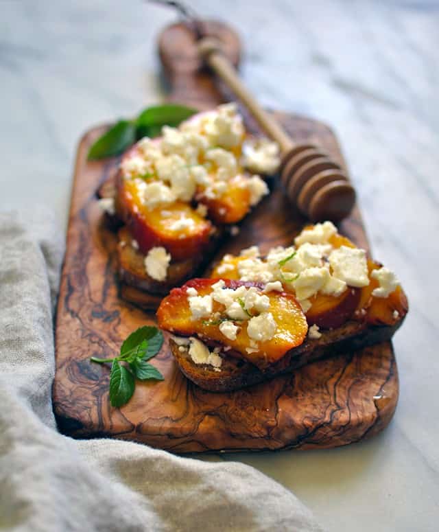 Grilled Peach Crostini with Feta and Fir Honey Turntable Kitchen