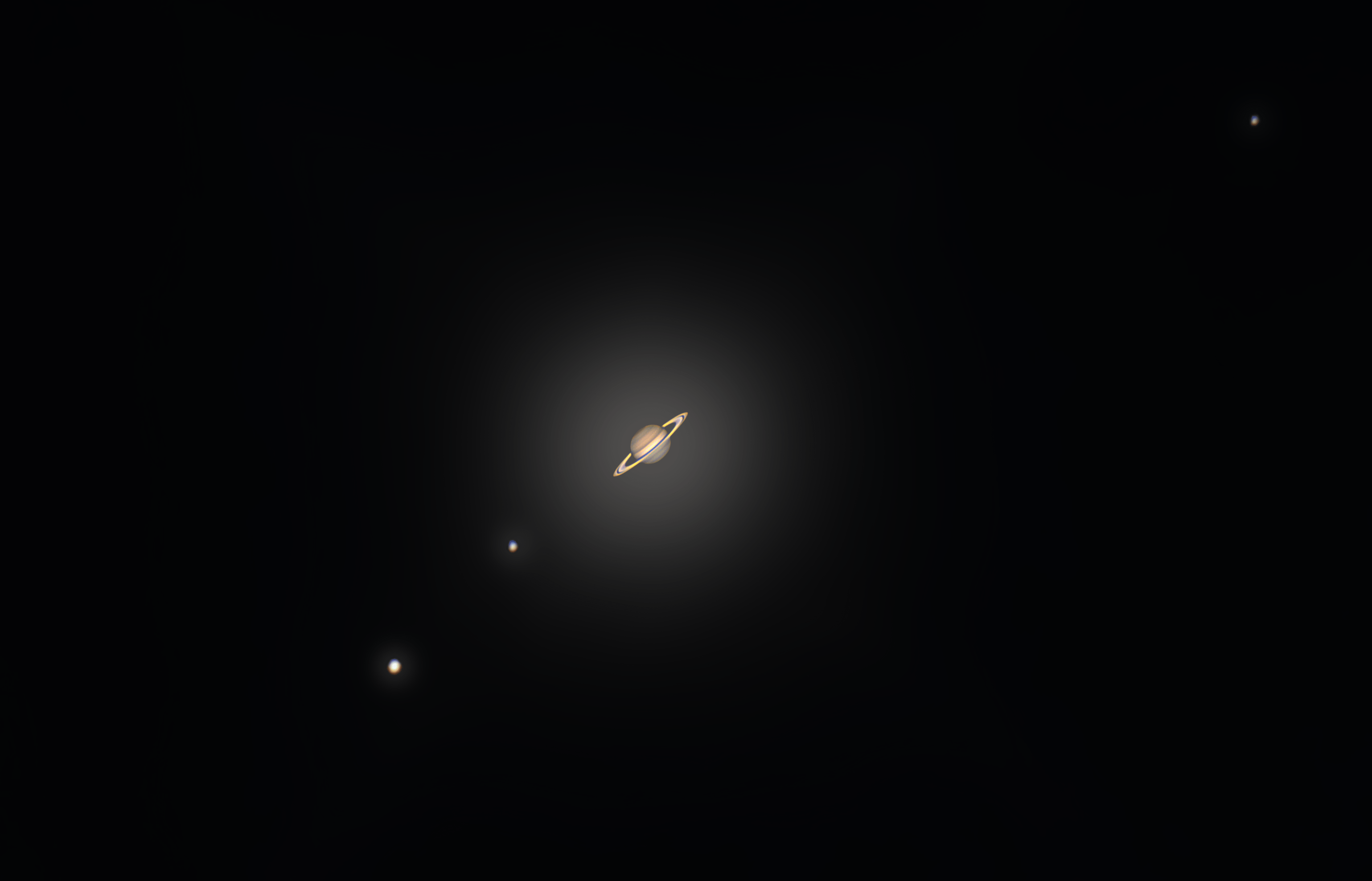 Saturn and its 3 biggest moons through my 8 inch telescope. I tried to