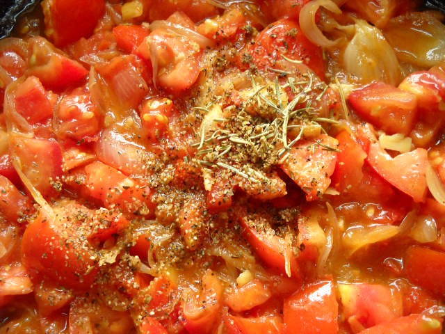 adding-herbs dried herbs added to the tomatoes.