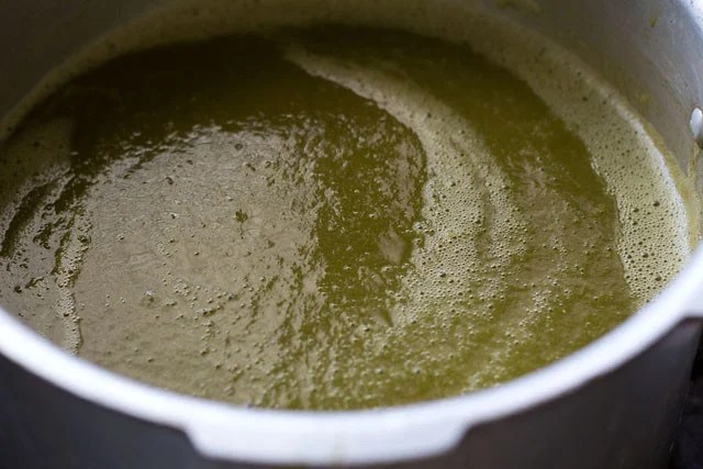 sarson-ka-saag12 adding greens puree in a pan to simmer more.