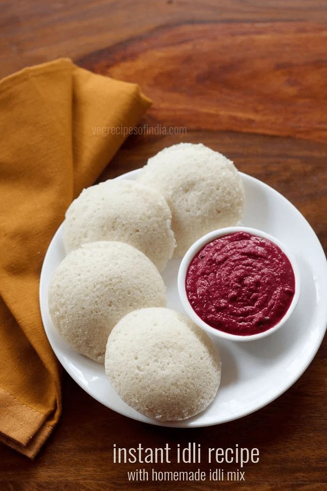 instant idli on a plate with beetroot chutney in a small bowl.