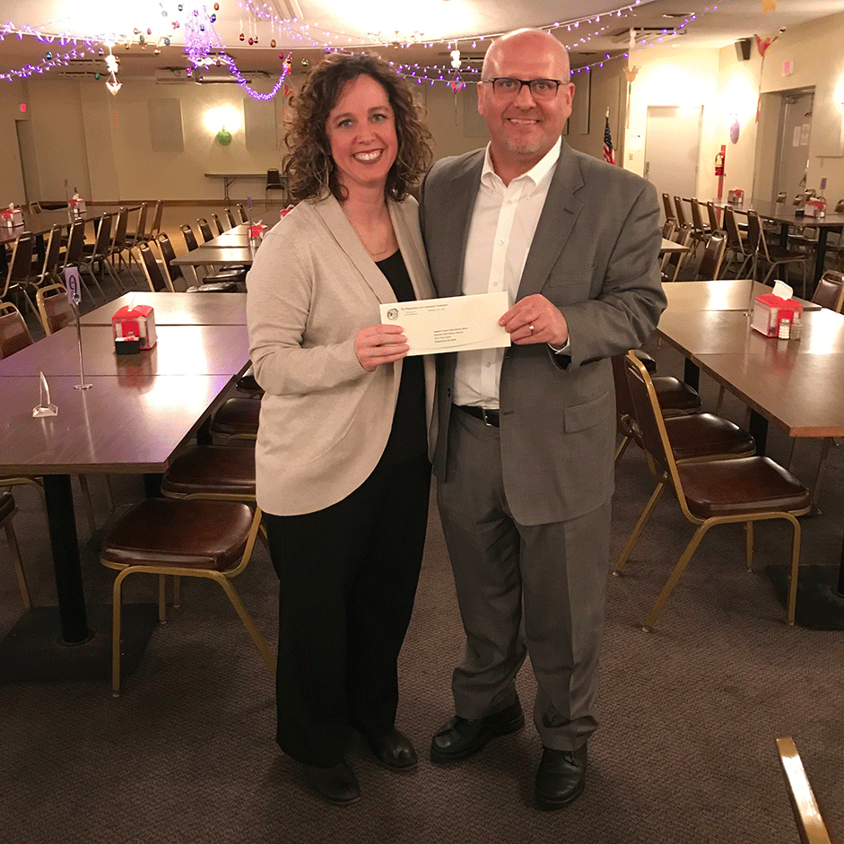 Board member Keith Horner, presents a Foundation grant check to Beth Steiner, Director of the