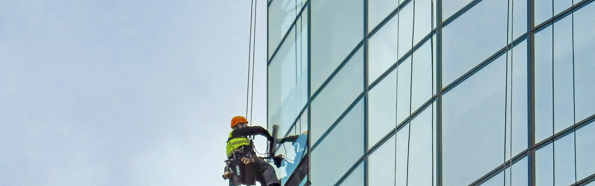 Skyscraper Window Cleaner on edge We Clean Commercial Contract