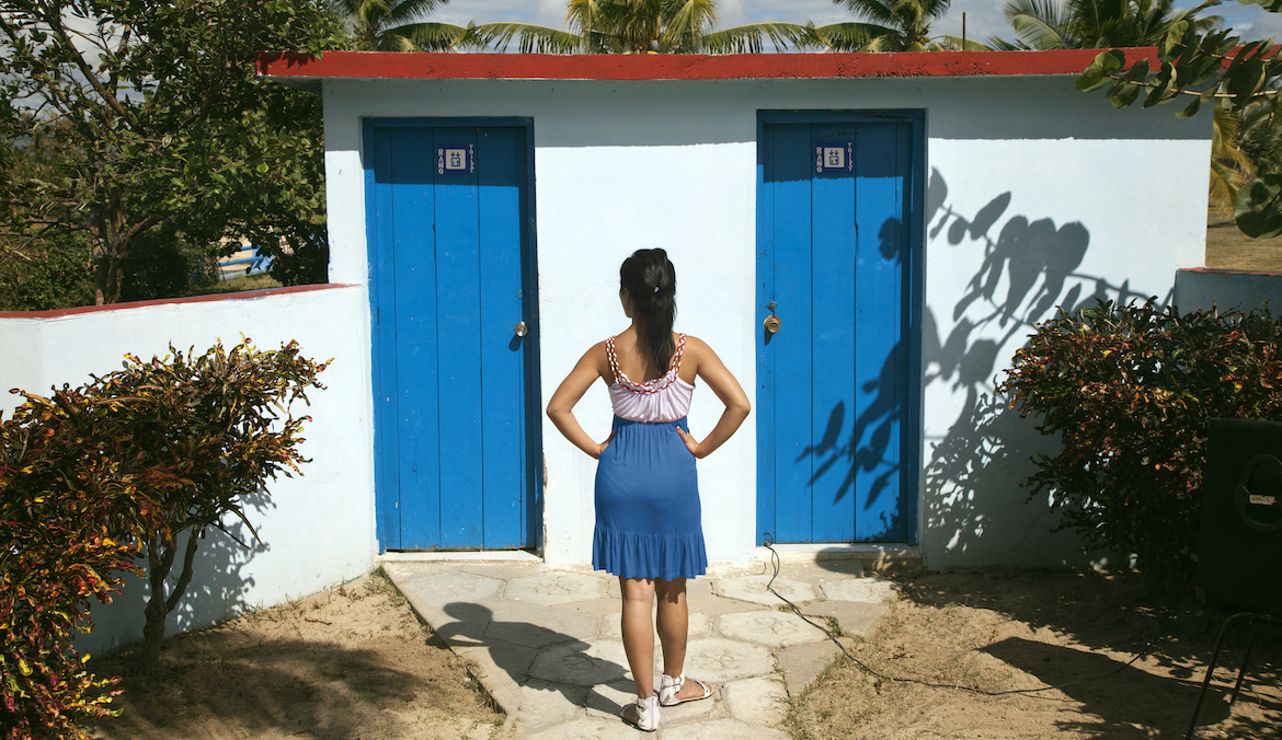 Experts Explain Why You Should Sit Down on Public Toilets Well+Good