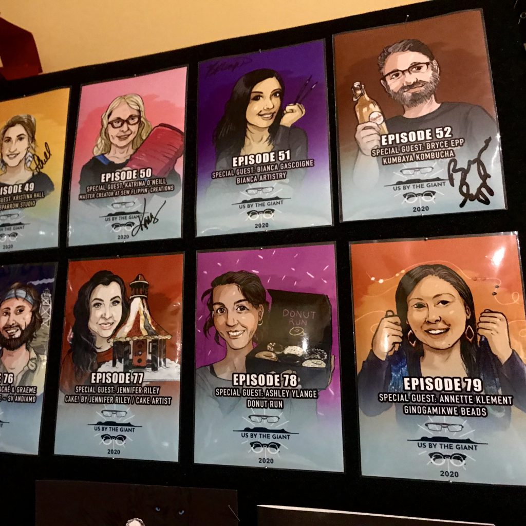 Us by The Giant Podcast studio wall of past guests