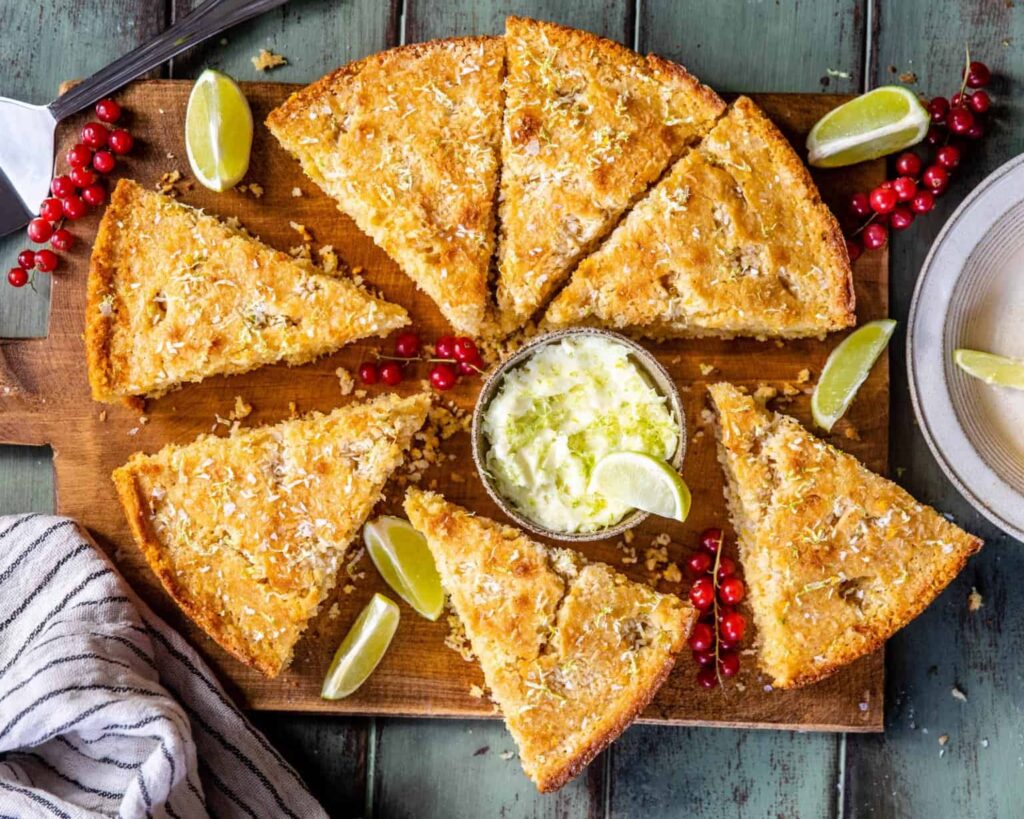 Slices of coconut cornbread on a cutting board.