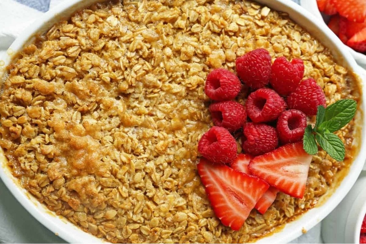 Indulge in a delicious bowl of oatmeal topped with fresh strawberries and raspberries.