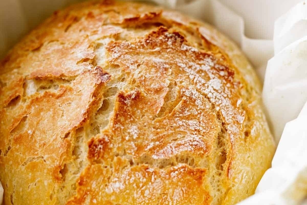 A loaf of bread from bread recipes sitting in a paper bag.