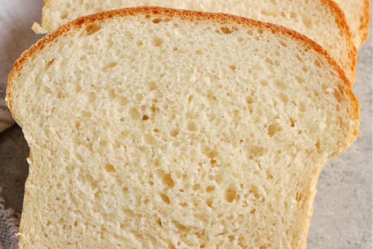 Three slices of white bread, perfect for bread recipes, on a table.