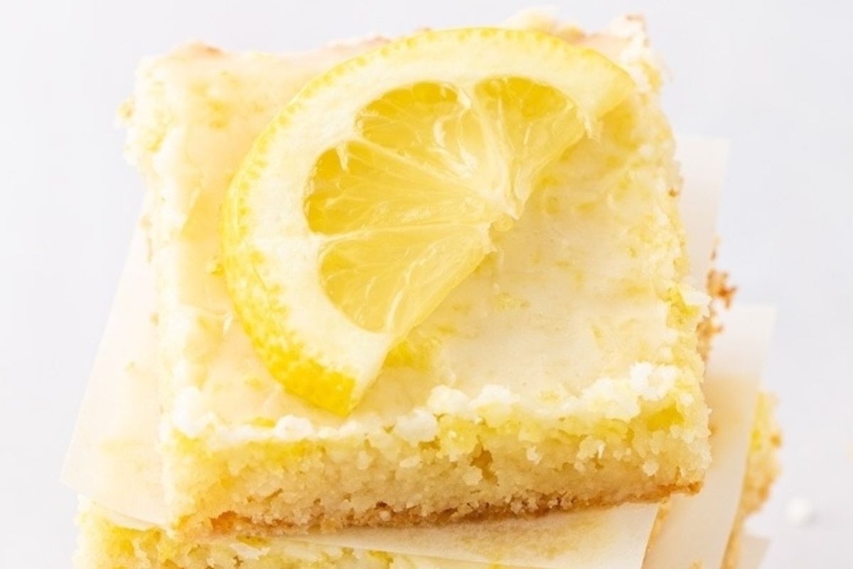 A stack of lemon bars from Bisquick recipes with a slice of lemon on top.