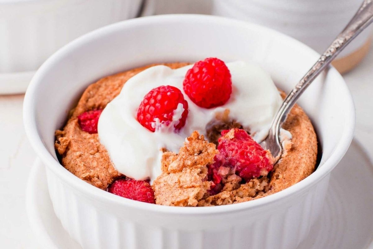 Indulge in a delicious bowl of oatmeal with raspberries and cream, perfect for a nutritious breakfast or snack option.